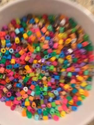 A post by @jackmojis on TikTok caption: Made a perler bead bowl for my sister to put her scrunchies in #art #foryou