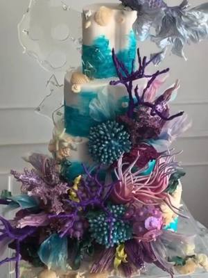 A post by @weddingsnevents on TikTok caption: A full under the sea experience with this stunning cake masterpiece! #weddingcake #eventdesign #levelup