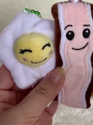 A post by @toytinyblog on TikTok caption: What goes best with eggs? 🍳 🥓 #plush #plushies #kawaiifood #toyfood