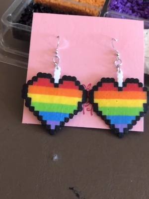 A post by @amorecreativeray on TikTok caption: ❤️🧡💛💚💙💜 #perler #perlerbeads #art #fyp #foryou #foryoupage #cute #earrings #Pride #lgbtq #KeepingItCute #handmade