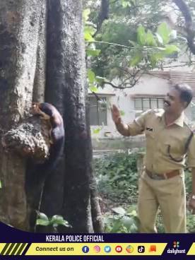 A post by @keralapolice on TikTok caption: കാക്കിയുടെ കാരുണ്യം...                                                                   ഷോക്കേറ്റ് നിലത്തുവീണ മലയണ്ണാനു രക്ഷകനായി  പോലീസ് ഉദ്യോഗസ്ഥൻ