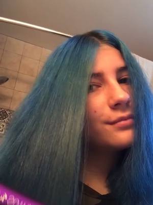 A post by @regina.does.pottery on TikTok caption: I’m not sure how I feel about it, what do you guys think? #bluehair #middlepart #hairtransformation #foryou #BeautyReview #fyp #react