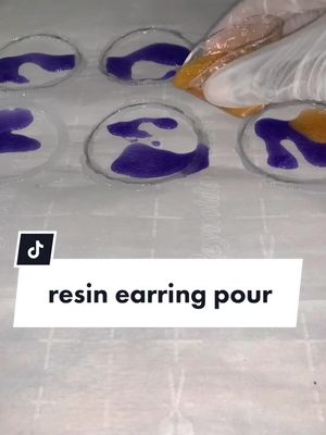 A post by @raiiniie on TikTok caption: Purple Black & Gold earring sets. #resinart #earrings #jewelry #epoxyresin #handmadejewelry