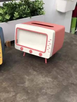 A post by @sharegoodthing1 on TikTok caption: TV-shaped tissue box, you can also put your mobile phone#tissuebox #Home