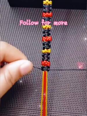 A post by @origamihero on TikTok caption: Have you learned it? 🥳. #weave #bracelet #knittingrope #TimeforTENET