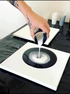 A post by @ on TikTok caption: #artist #fyp #supportlocalartists #art #fluidart #acrylicpour #blackandwhite