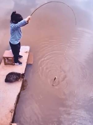 A post by @fishman8888 on TikTok caption: 👧🏻 🐈 🎣 a little fisher girl #fish #fishtok #fisherman #fishtok