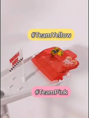 A post by @premiermarbleracing on TikTok caption: #sponsored by @step who's winning this #marblerace ? #teamyelloe or #teampink ? comment who you are cheering for! #marblerun