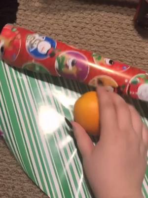 A post by @aprilcowles on TikTok caption: gave my brother an orange as a christmas present 🤭🎄 #fyp #CozyAtHome #christmas