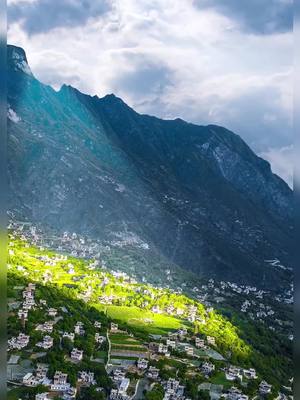 A post by @landscapesharer on TikTok caption: The old house on the nearby mountain, once used to escape floods, has now become a haven for tourists#landscape #village