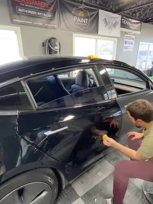 A post by @neauxlimitz on TikTok caption: Satin Black Tesla Model 3 #paintisdead #wrap #vinyl #fyp