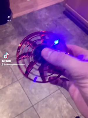 A post by @neonspinners.com on TikTok caption: Buy yours at NeonSpinners.com 🔥 #fidgetspinners #fidget #toys #ufo