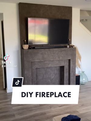 A post by @artandstef on TikTok caption: loved working on this fauxfireplace! #fyp #DIY #fixerupper #drywall #renovation #EnvisionGreatness