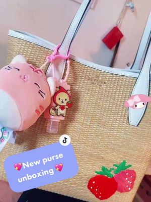 A post by @polkavona on TikTok caption: Got my first “nice” bag! Can’t wait to use it especially with summer! @katespade #katespade #strawberrypurse #strawberry #sanrio