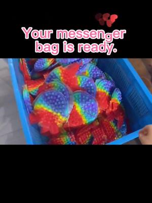 A post by @fidget_toys_shop001 on TikTok caption: your popit messenger bag is on the way. do u want it??? 😉😉😉 #fidgettoy #fidgettoys #popitbag #popit #popits #toy #messengerbag #fypシ