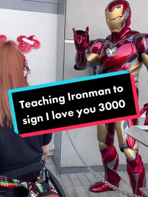 A post by @hannahcatelutz on TikTok caption: Teaching Iron man I love you 3000 #asl #deaf #marvel #disney #disneytiktok #marveltok #disability #wheelchair