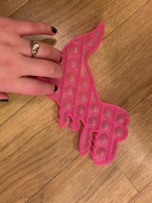 A post by @poppingsisters on TikTok caption: T-Rex 🦖 #fidgets #fidgetpopit #sisters #fyp