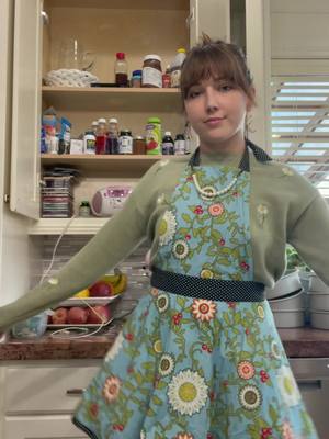 A post by @juliesnegur on TikTok caption: thrifted this amazing vintage apron with an attached pearl necklace there’s only a pocket on one side tho :’) also baker reveal?! #cakedecorating #ldr