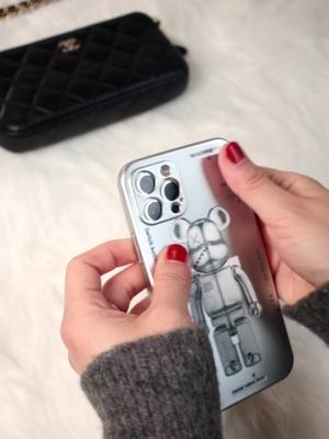 A post by @couplephonecase on TikTok caption: Unboxing with me! New bearbrick phone case ❤️❤️❤️#unboxing #phonecase #phonecover #phoneprotector #bearbrick #fyp