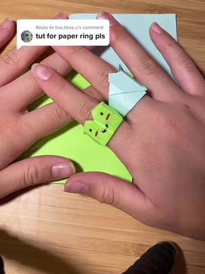 A post by @.0rigam1 on TikTok caption: Reply to @lisa.likes.u  if this is confusing pls tell me !! i’ll remake it 🥰 also lmk if u wanr the frog ring tut #ring #paperring #blue #postitnost #viral #foryoupage #fyp #fourupage #origami