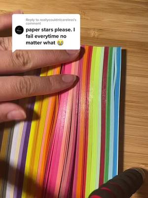 A post by @.0rigam1 on TikTok caption: Reply to @reallycouldntcareless  #star #origami #fyp #likes #follow #strips #colourful #paper