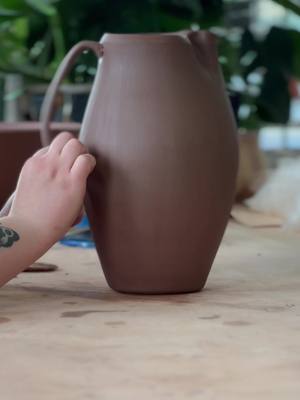 A post by @summerhallpottery on TikTok caption: Adding a handle to the pitcher I threw last week! ✨ #pottery #potteryvideos #claysmr #calming