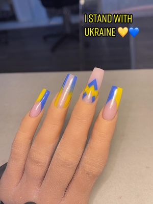 A post by @carlyreillynailartist on TikTok caption: I stand with Ukraine 🇺🇦 💛💙 #nails #ukraine #istandwithukraine