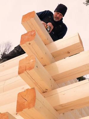 A post by @thisismyalaska on TikTok caption: Up Go The Walls! #alaska #logcabin #offgridliving #thisismyalaska