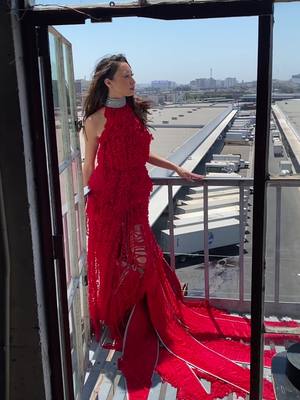 A post by @jvvixen on TikTok caption: Thinking back to…One of my #jerseyvirago couture dresses in LA ❤️❤️❤️ #seattlefashion #couture #fashiondesigner #fashiondesign #reddress #avantegarde #wearableart #fyp