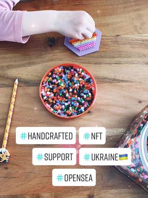 A post by @crazyleeggooo on TikTok caption: 5 year old viral girl selling her iron on beads as NFTs to support Ukraine #ukraine🇺🇦 #support #nft #opensea #united