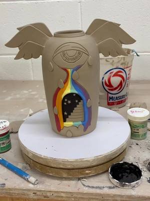 A post by @dirtworks_ceramics on TikTok caption: 🕳🕳🕳🕳 #runningupthathill #portal #doorway #fyp #wings #rainbow