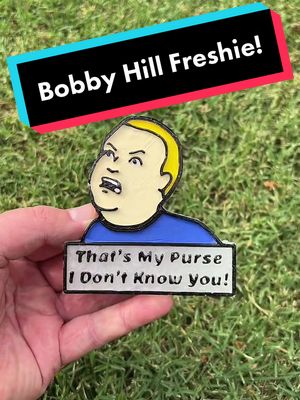 A post by @freshiesbyturtle on TikTok caption: Bobby Hill car Freshie 👜 #kingofthehill #bobbyhill #hankhill #carfreshies #freshiesinthemaking #howto #fypシ