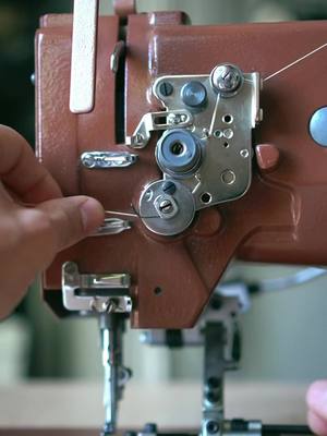 A post by @lowtideleather on TikTok caption: Threading an industrial sewing machine 🪡 #leathercraft #saddlestitch #patina #leathergoods #handmade #handstitch #handcrafted #toolsofthetrade #leatherworking #vegtanleather #howtovideo #supporthandmade #craftbuzz #workinprogress #craftersofinstagram #makingvideo #processvideo #wip #leatherwallet