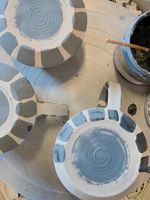 A post by @pinetreepottery on TikTok caption: spinning vinyl inspired mugs 🎧 #fyp #foryou #pottery #ceramics #handmade #artist #art #clay #painting #wheel #throwing #satisfying #SmallBusiness #boiseidaho #womanowned