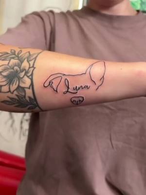 A post by @dahmsamm on TikTok caption: had this idea becore we found out she has cancer, now it means even more to me 🌎💙 #pitbullsoftiktok #tattoo #dog