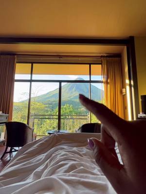 A post by @dopeethiopian on TikTok caption: Easily the most stunning view to wake up to. 🥹 Arenal Volcano • Costa Rica 