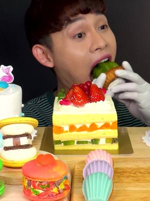 A post by @eatwithbonggil on TikTok caption: Vacation Cakes with Rainbow Madeleine Milk Macaron MukBang~!! #mukbang #fyp #mukbangbonggil #asmr #bonggil #bonggil_asmr #eating #delicious #asmrfood #yummy #eatingshow #foodtiktok #foryou #foodchallenge #food #fypシ゚viral 