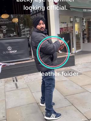 A post by @averyrwalsh on TikTok caption: Lucky eye scammer looking offical with his leather folder and business cards. has anyone been scammed by them before? Do you think he is a real Sikhs? #scammergetscammed #scam #scammer #london #sikhs 