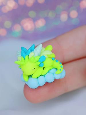 A post by @hopienoellecharms on TikTok caption: Cloud creations I kept for myself :D  #kawaii #aesthetic #clayart #polymerclay #fimo #claycracking #dragons #unicorn #fantasy #artist #handmade #SmallBusiness #pastel #rainbow #kidcore #fairycore