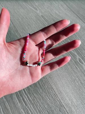 A post by @junes.jewels on TikTok caption: new bracelet! 💝🫶 #christmas #jolly #winter #holly #holiday #claybead #claybeads #Claybeadbracelets #junesjewels #beadedjewelry #preppy #beads #Claybeads #seedbeads #bracelets #necklace #preppybracelets #fyp #foryou #blowup #trendy #trend #viral #fypシ #colorful #bright #star #gold #goldstar