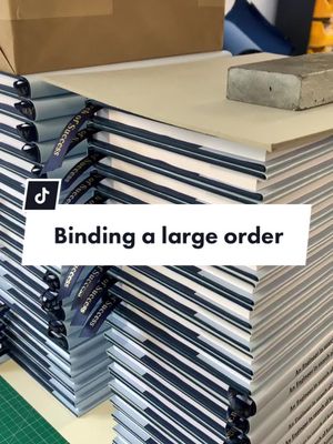 A post by @walkerprintltd on TikTok caption: Binding a large order. Watch our bookbinders bind a 60 volume order over the past few weeks; here the client also requested a personalised register ribbon along with custom dust jackets.  #asmr #asmrvideo #oddlysatisfying #oddlysatisfyingvideo #bookbindersoftiktok #bookbinder #fyp #BookTok 