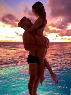 A post by @polecouple on TikTok caption: Most colourful sunset ever 😍 #polecouple #dmitryfedotov #dimitryfedotov #alenakuzmina #anelakuzmina #poolfun #poolvibes #summervibes #bali #balinewyear #couplegoals #sunset #balisunset #oceanview #oceansunset #bali