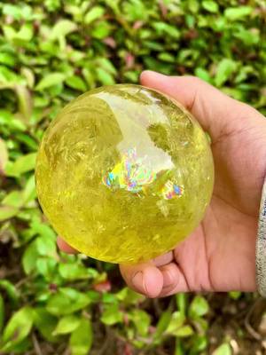 A post by @ng_crystal_factory on TikTok caption: So amazing citrine sphere full of rainbow 🌈 #citrin #crystal #citrin sphere 