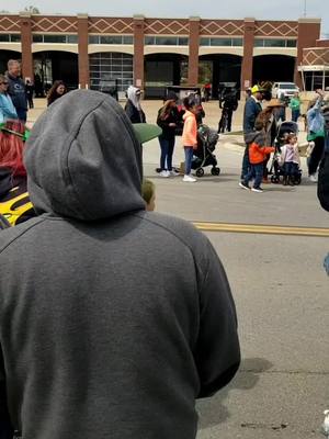 A post by @skatefather on TikTok caption: Why is this dude always blocking me from waving at dinosaurs? #pickleparade #stpatricksday #dinosaur #dinosaurs #pickle #mansfieldtx #saintpatricksday 