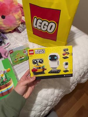 A post by @khaliluzivert on TikTok caption: Sold out online but check with your local store for Wall-e and Eve!!!! #lego #walleandeve #pixar #easterlego #florallego 