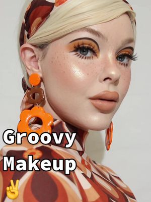 A post by @beatsbylizzie on TikTok caption: Groovy makeup vibes ✌️#groovymakeup #70smakeup #70smakeuplook  #orangemakeuplook #orangemakeup 