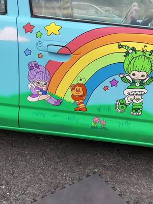 A post by @froggyfunhouse on TikTok caption: Paint my car with me, part two! I was able to finish the passenger side door today! Im super happy with how it came out, make sure to come back for part three! #rainbowbrite #nostalgia #80scartoons #painting #car #customcar #carpainting #rainbow #colorful #melaniemartinez #fairysoiree 