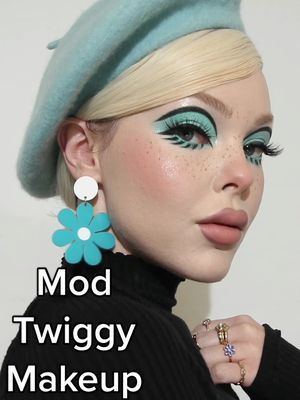 A post by @beatsbylizzie on TikTok caption: Mod makeup with Twiggy lashes 💙 #twiggyeyeliner #modmakeup #60smakeuplook #60smakeup #twiggymakeup #bluemakeup 