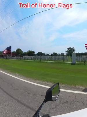 A post by @tybullet on TikTok caption: American Legion Post #20 places well over 2 miles of flags leading to the National Cemetery #memorialday  #trailofhonor #fortgibson