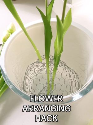 A post by @twinklecleaningduo on TikTok caption: I thought I would quickly share this simple and easy tip on how to keep your flowers standing evenly in your vase.  I add some chicken wire to the inside of the vase. The small and even holes are perfect to slot the stems into keeping the flowers spread out and standing tall. #flowerdisplay #flowers #flowersoftiktok🌷🌷  #tipsofinstagram #tipsandtricks #flowertips #homedecor #homeorganizing #organising #organisemyhome #organisedlife #sundaymotivation 